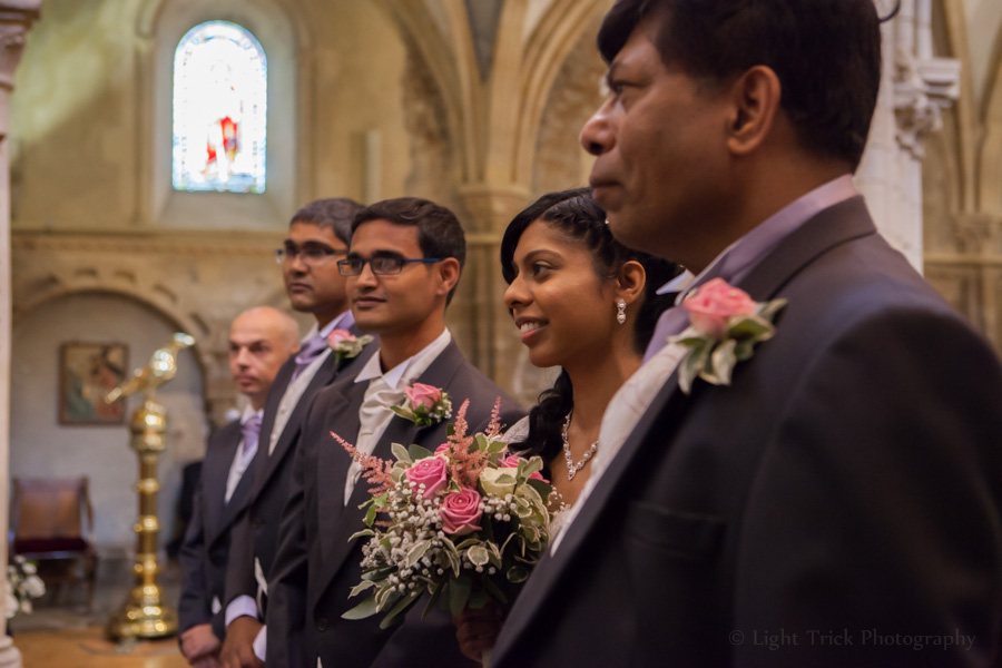 bride, groom, best man and father at the altar